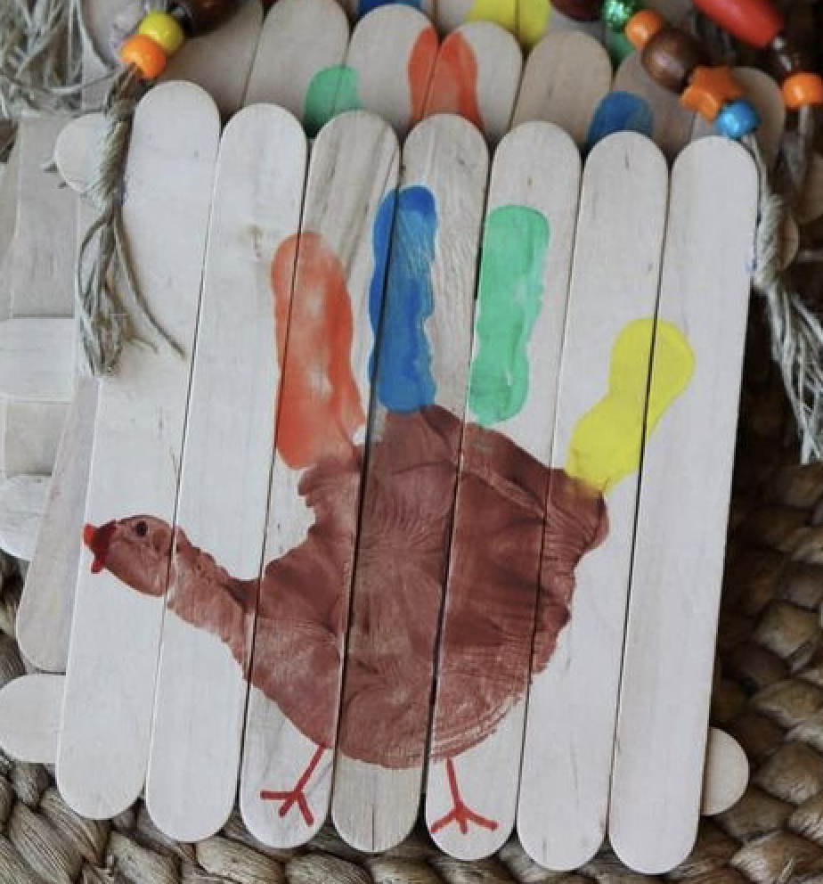 Turkey made from handprint on popsicle sticks glued together for a canvas