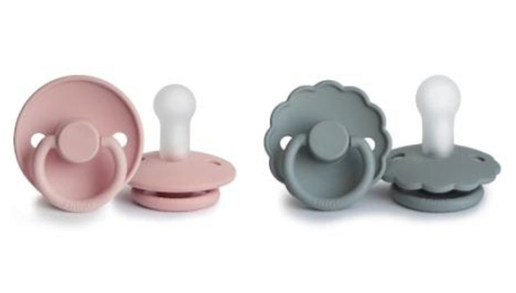 2 pink pacifiers and 2 grey pacifiers on a plain white background